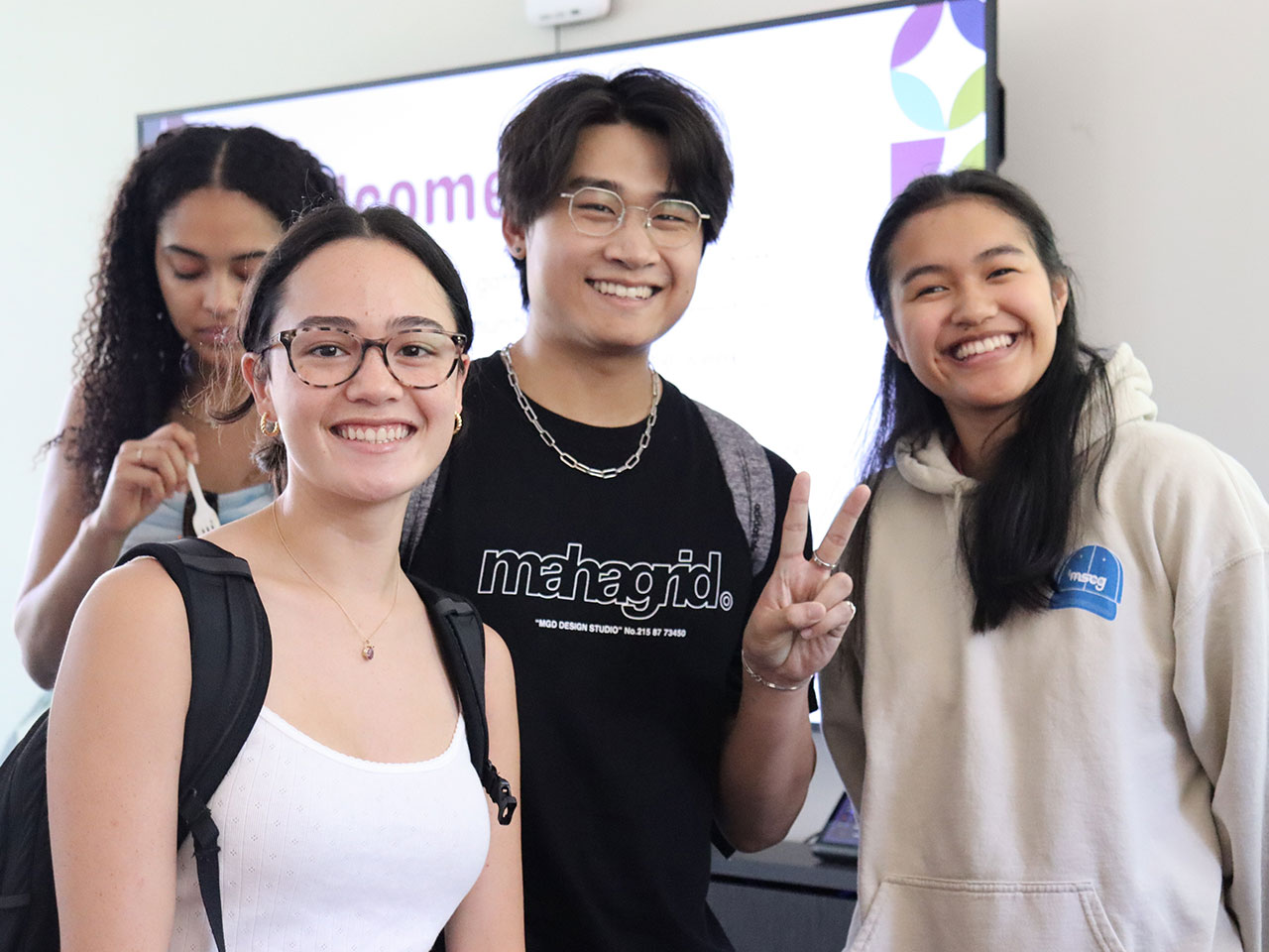 Four students facing the camera, smiling