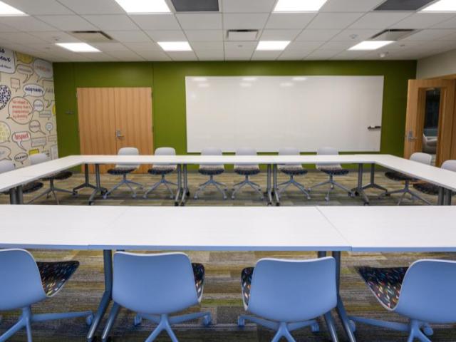meeting room with tables in a square and chairs